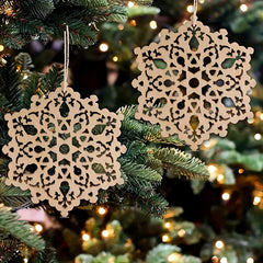 Decorative lace snowflake ornaments on a Christmas tree with blurred lights in the background.