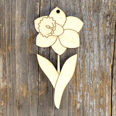 Wooden daffodil ornament on a wooden background