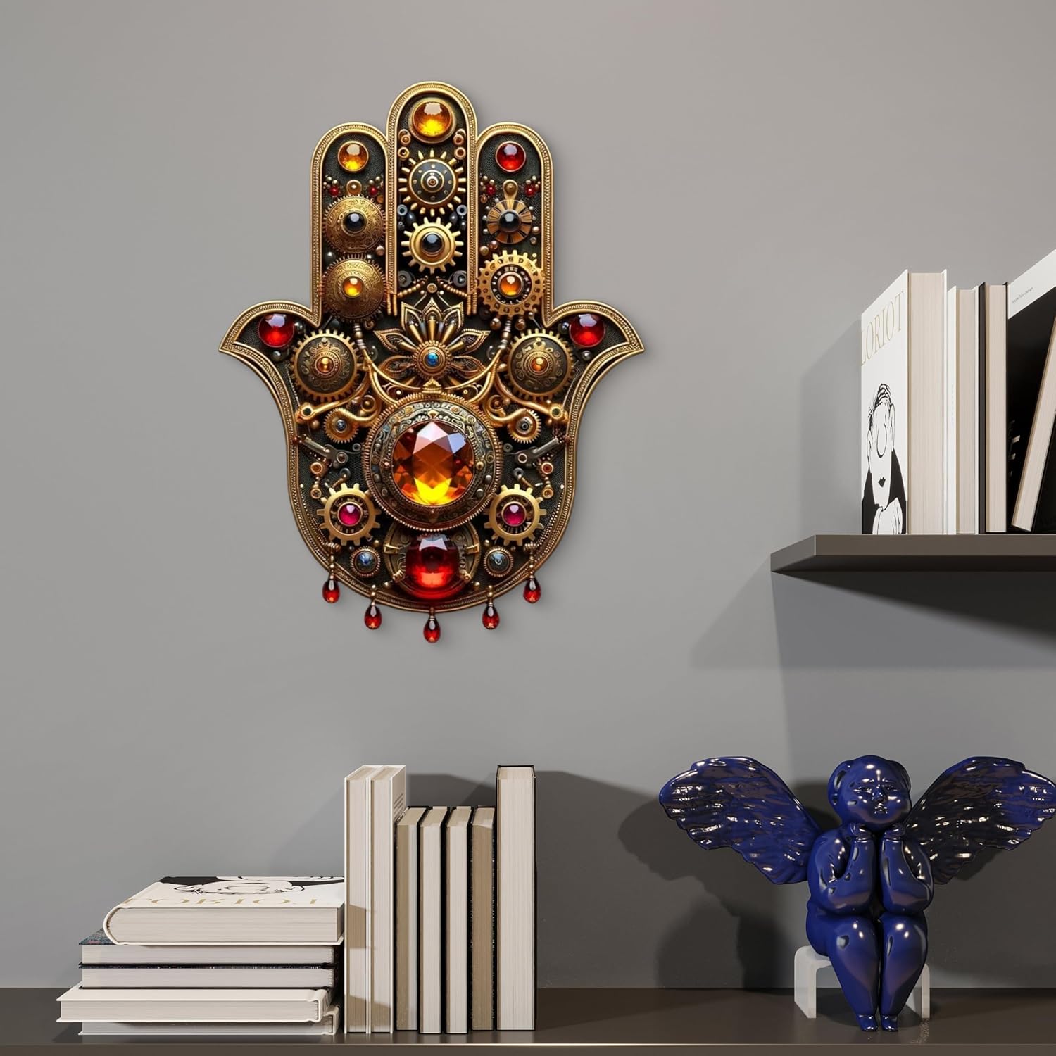 Decorative wall art resembling a Hamsa hand with gemstones on a gray wall with books and a sculpture.