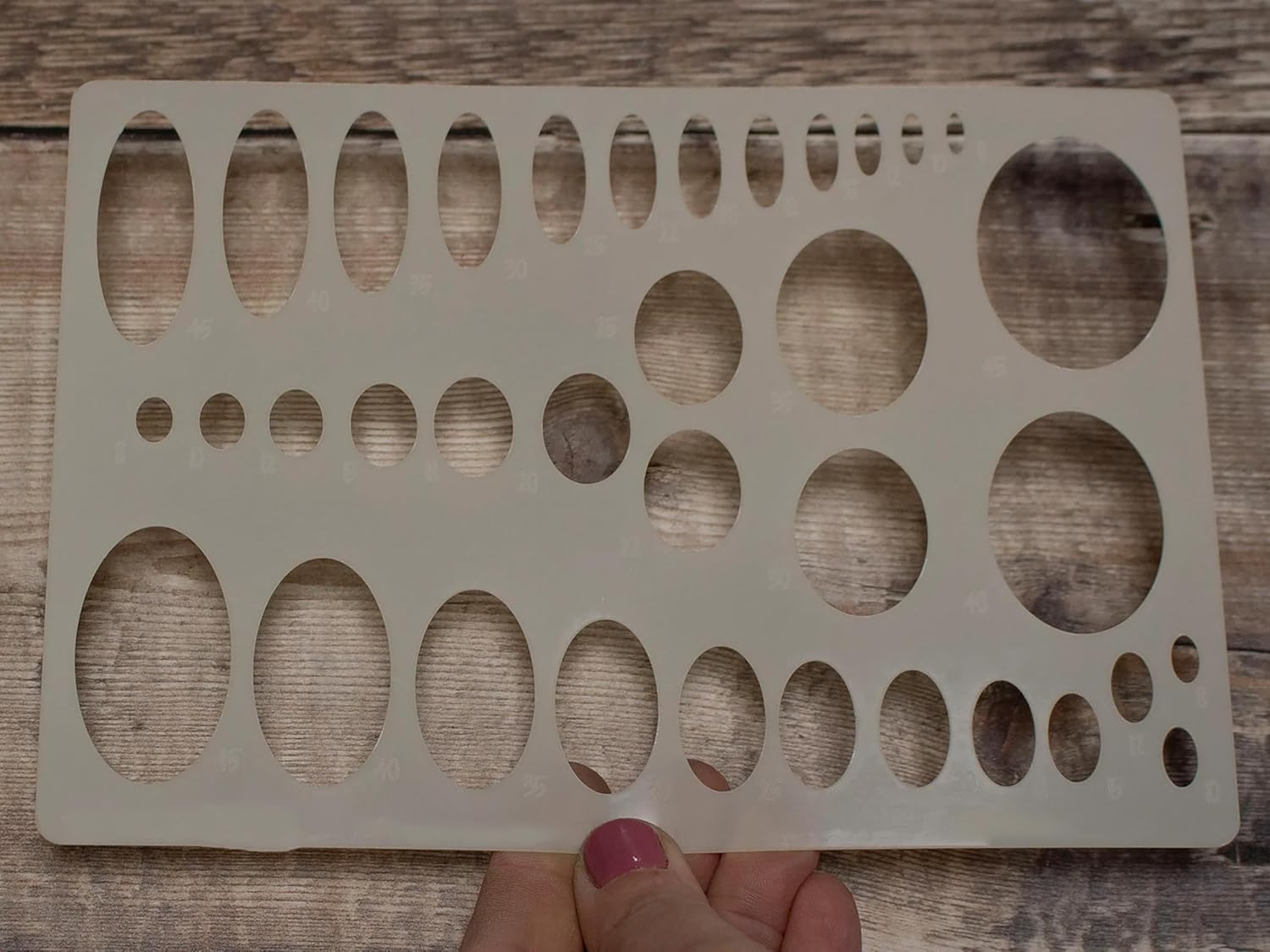 Wooden pegboard with holes on a wooden surface