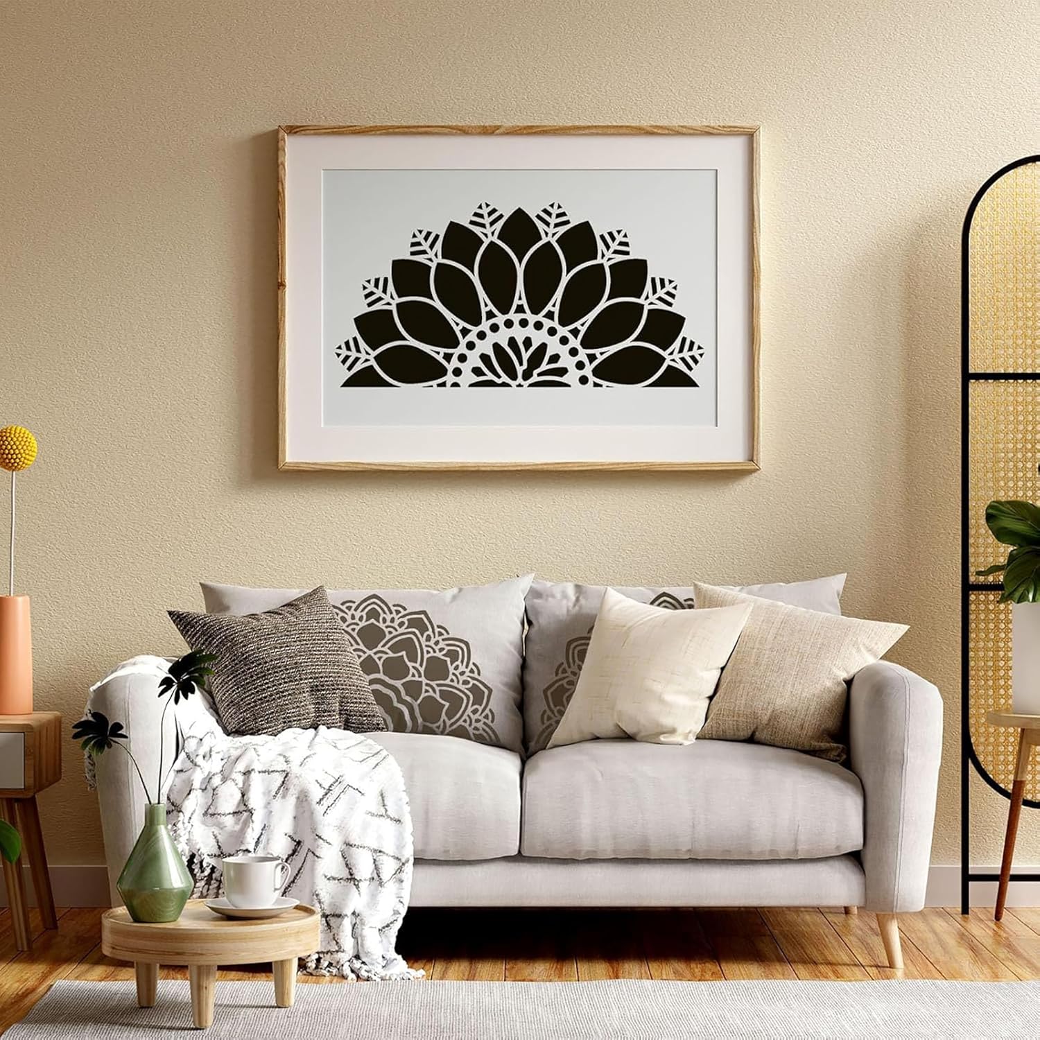 Living room with a white sofa, decorative pillows, and a framed black and white artwork on the wall.