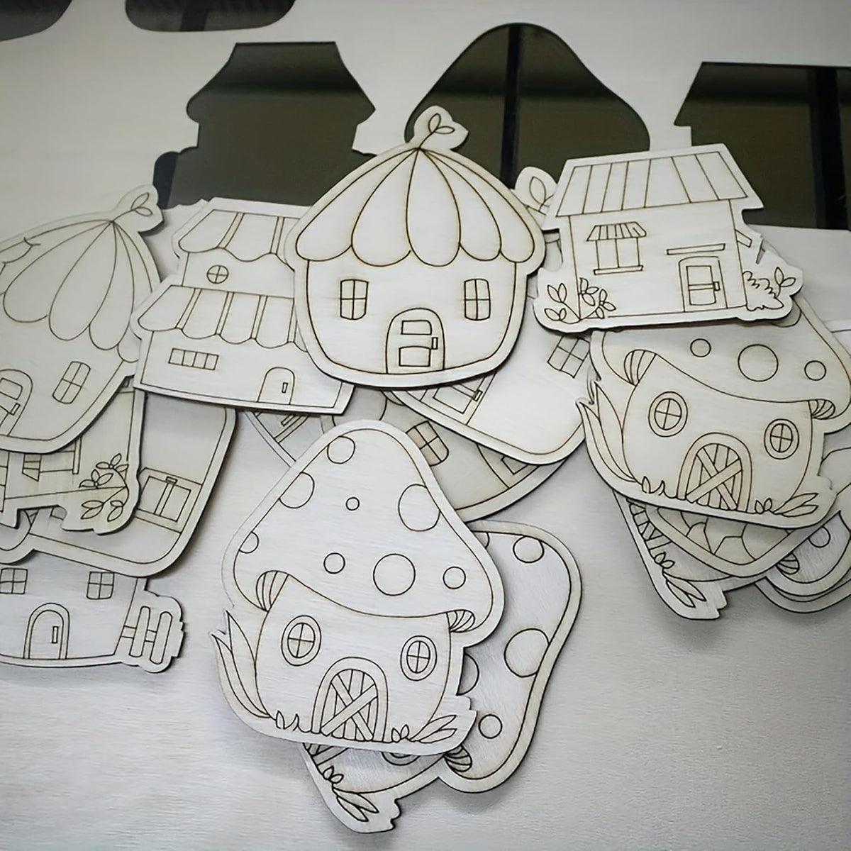 Collection of paper house cutouts on a white surface