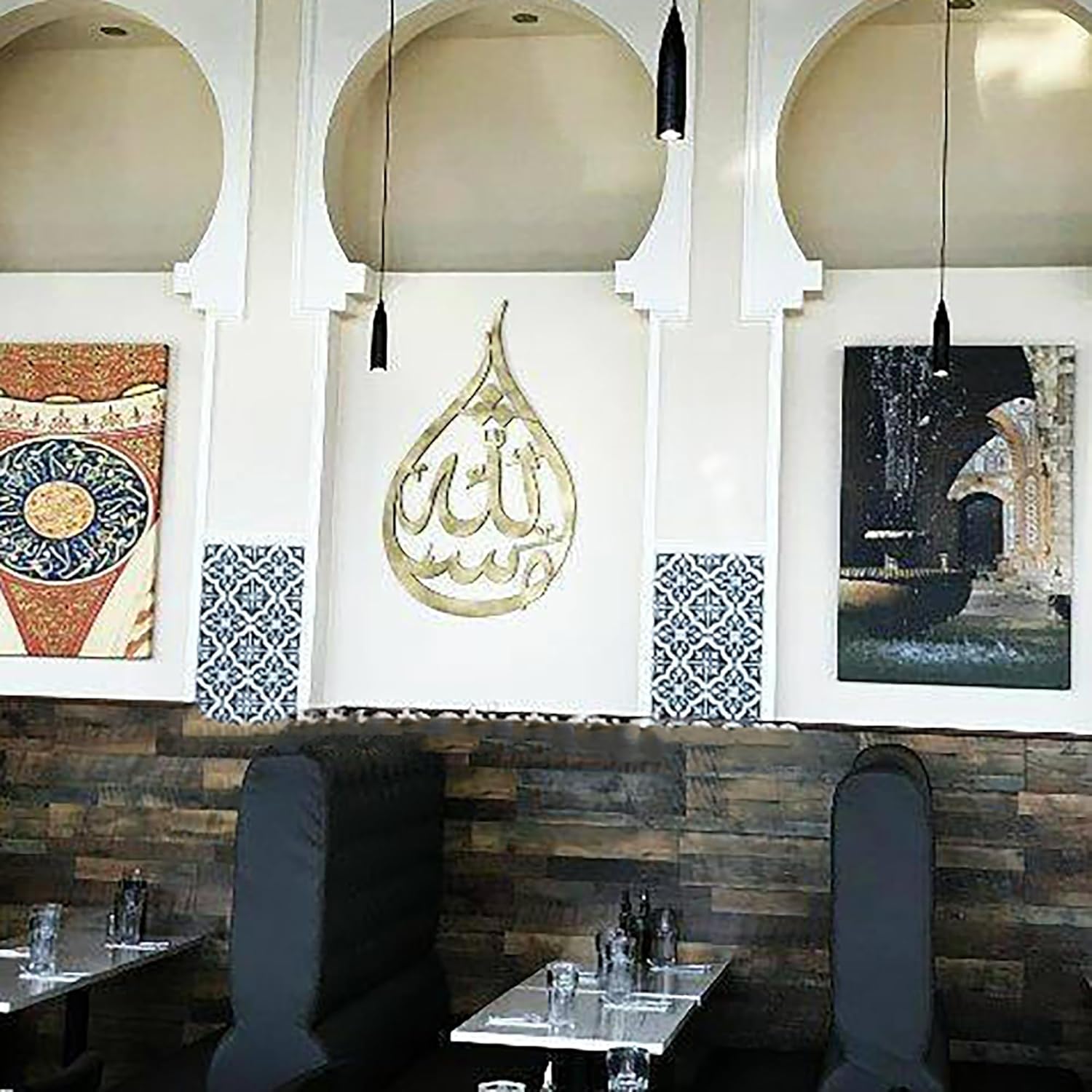 Decorative interior of a restaurant with Arabic calligraphy and artistic wall pieces.