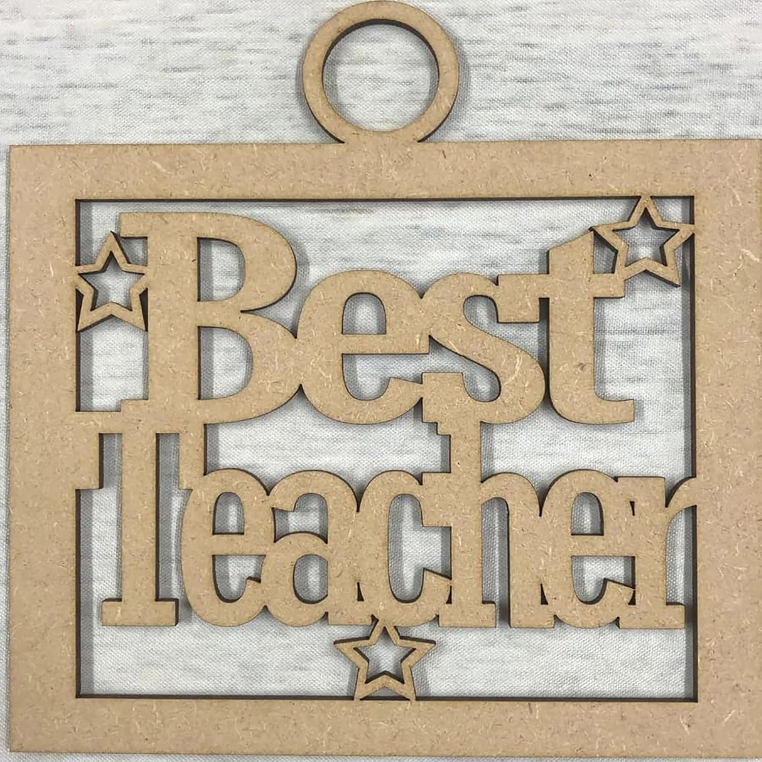 Decorative wooden cutout with 'Best Teacher' text on a textured background