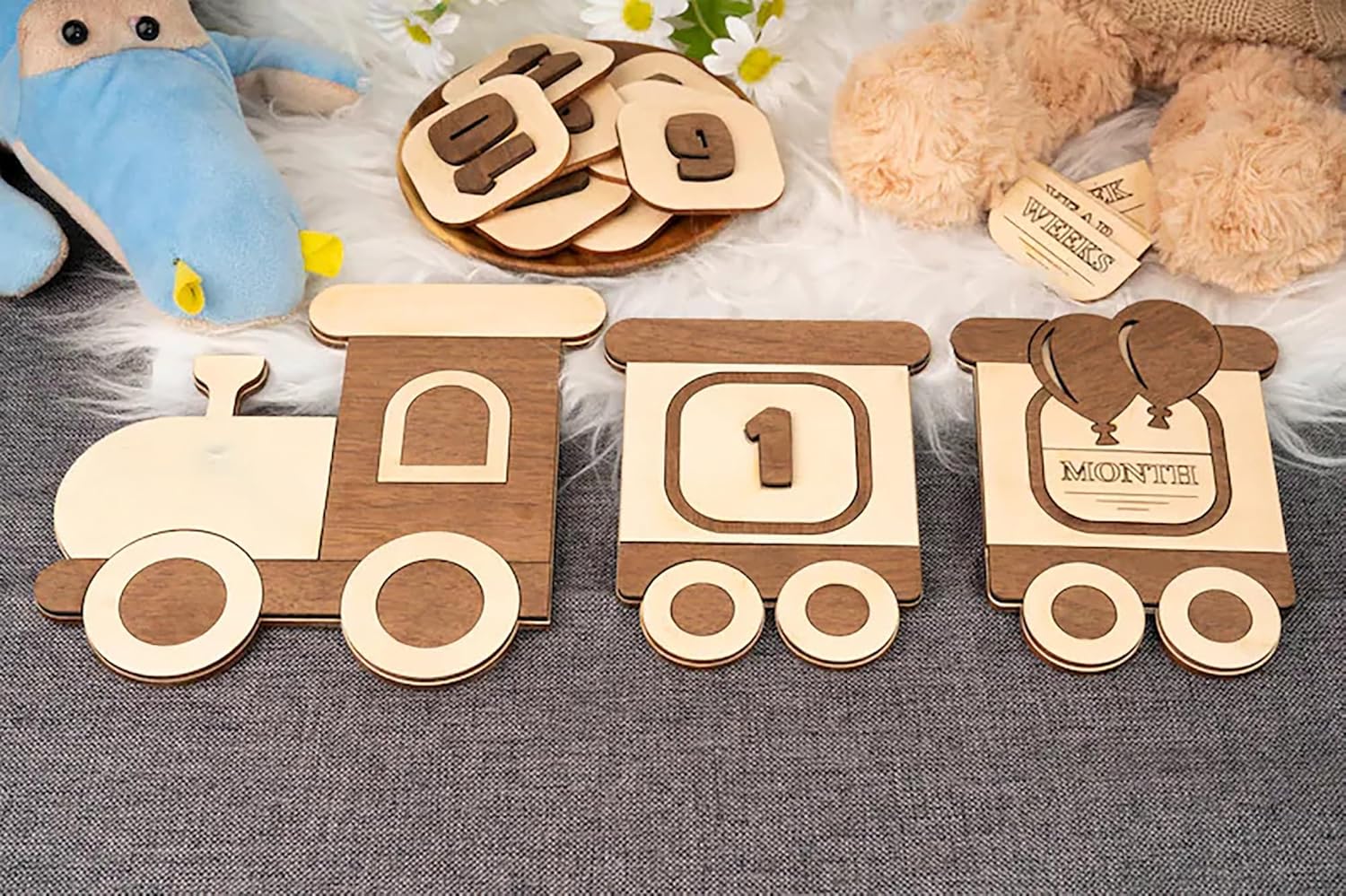 Wooden toys shaped like a train with numbers and letters on a textured surface.