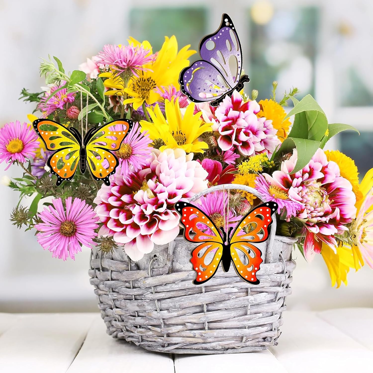 Bouquet of flowers with butterflies in a basket on a blurred background