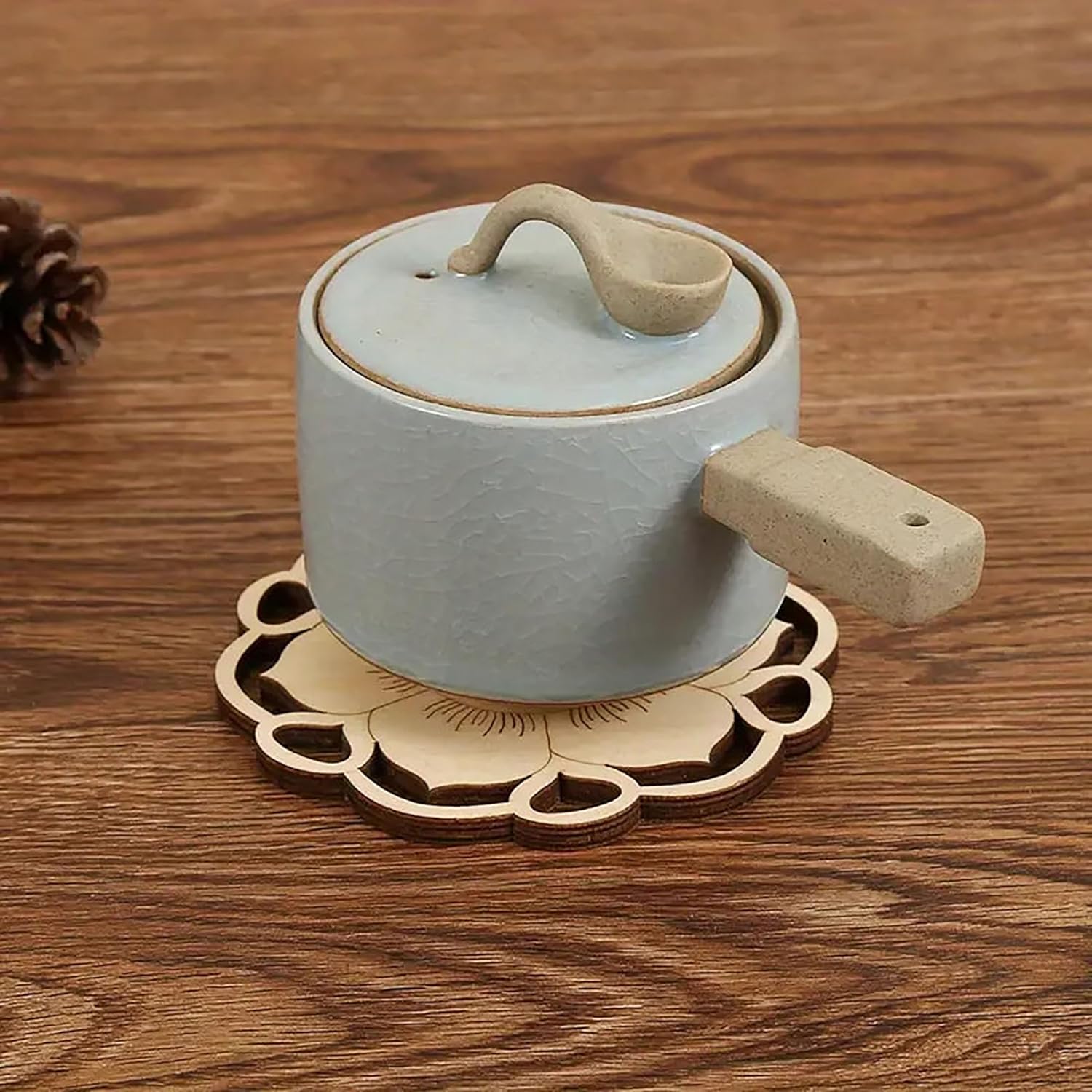 Ceramic pot with lid on a wooden surface