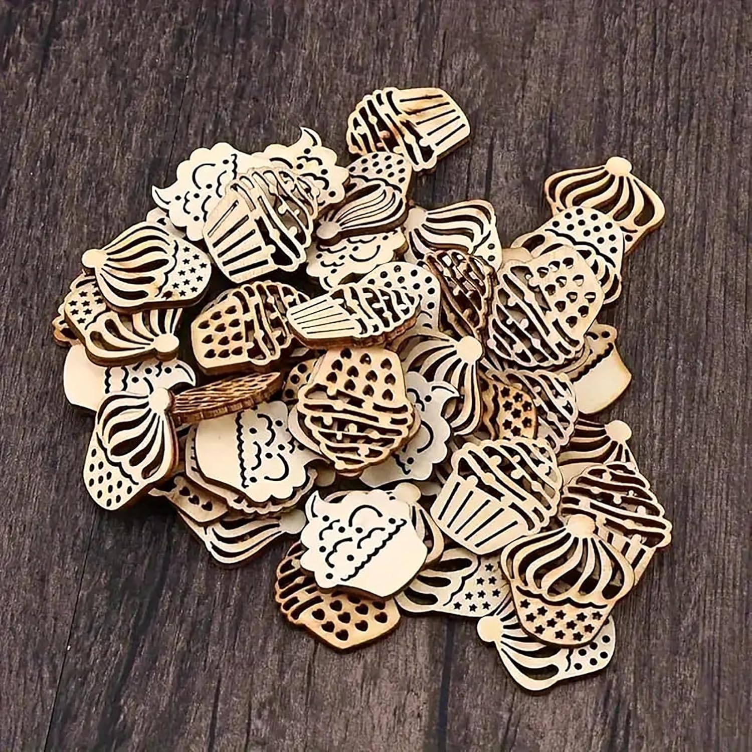 Collection of wooden cupcake-shaped cutouts on a dark wooden surface