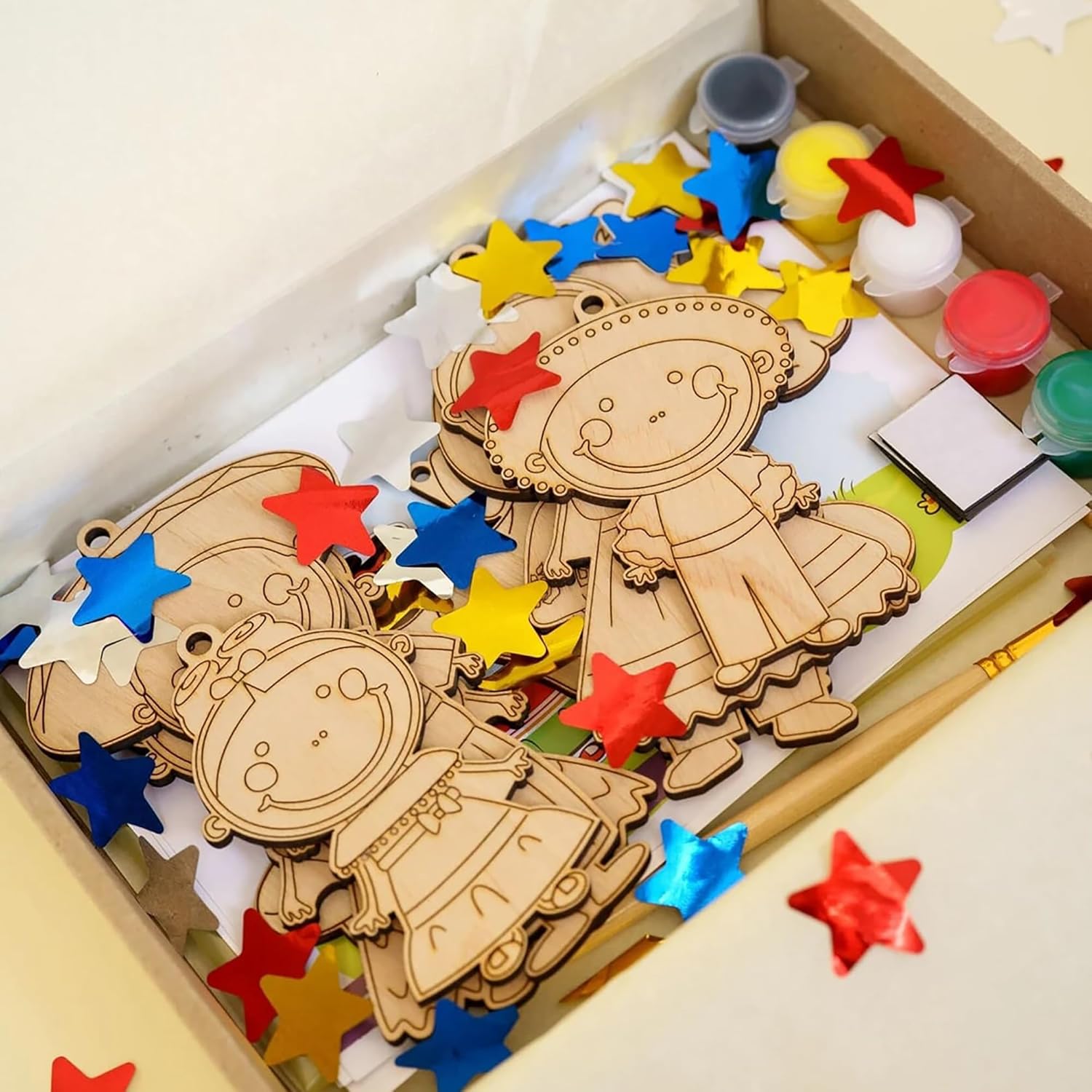 Wooden ornaments with colorful star decorations on a white surface
