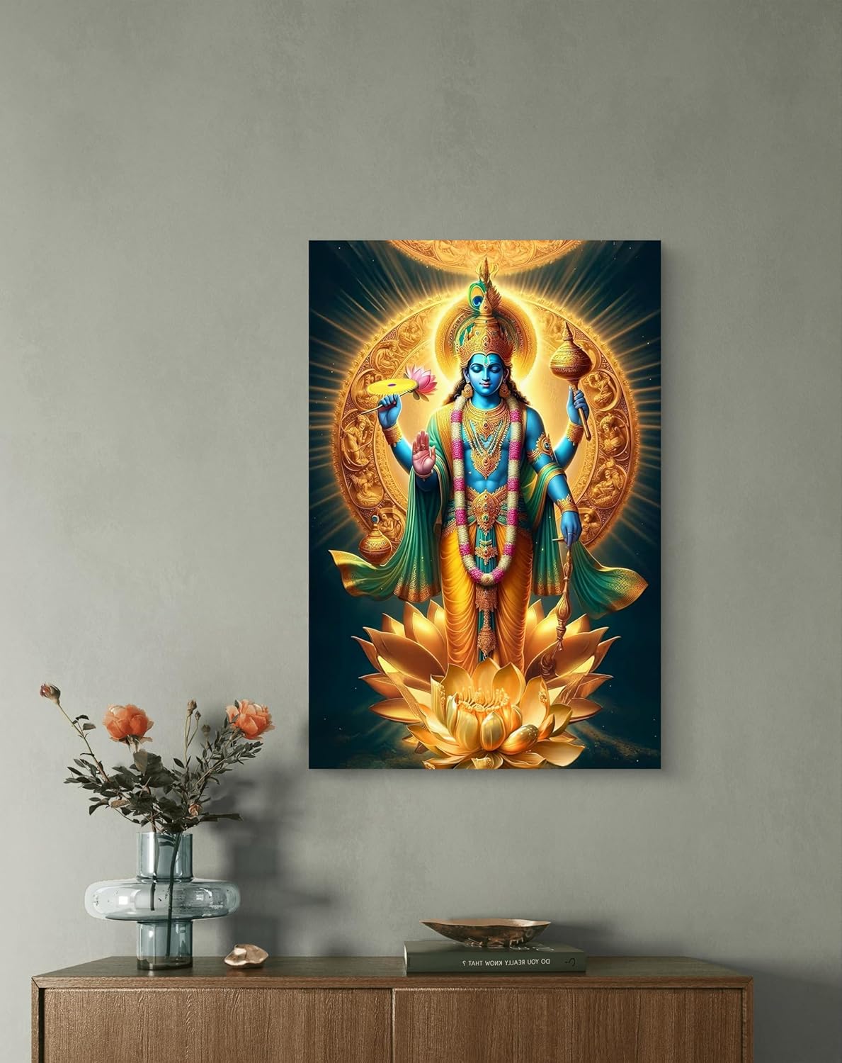 Canvas print of a colorful deity on a wall above a wooden cabinet with decorative items.