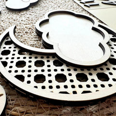 Close-up of decorative wooden coasters with geometric patterns on a textured surface.