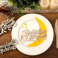 Decorative plate with 'Ramadan Kareem' text and a yellow crescent moon on a wooden surface.