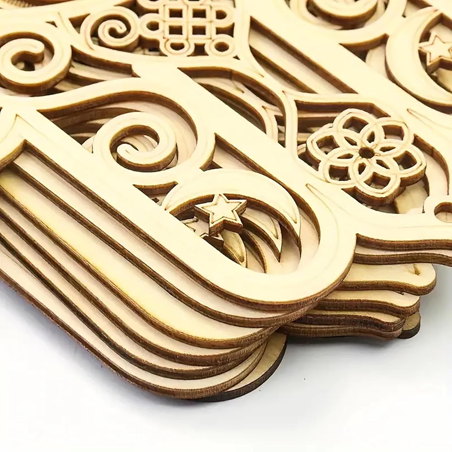 Stack of wooden decorative pieces with intricate carvings on a white background