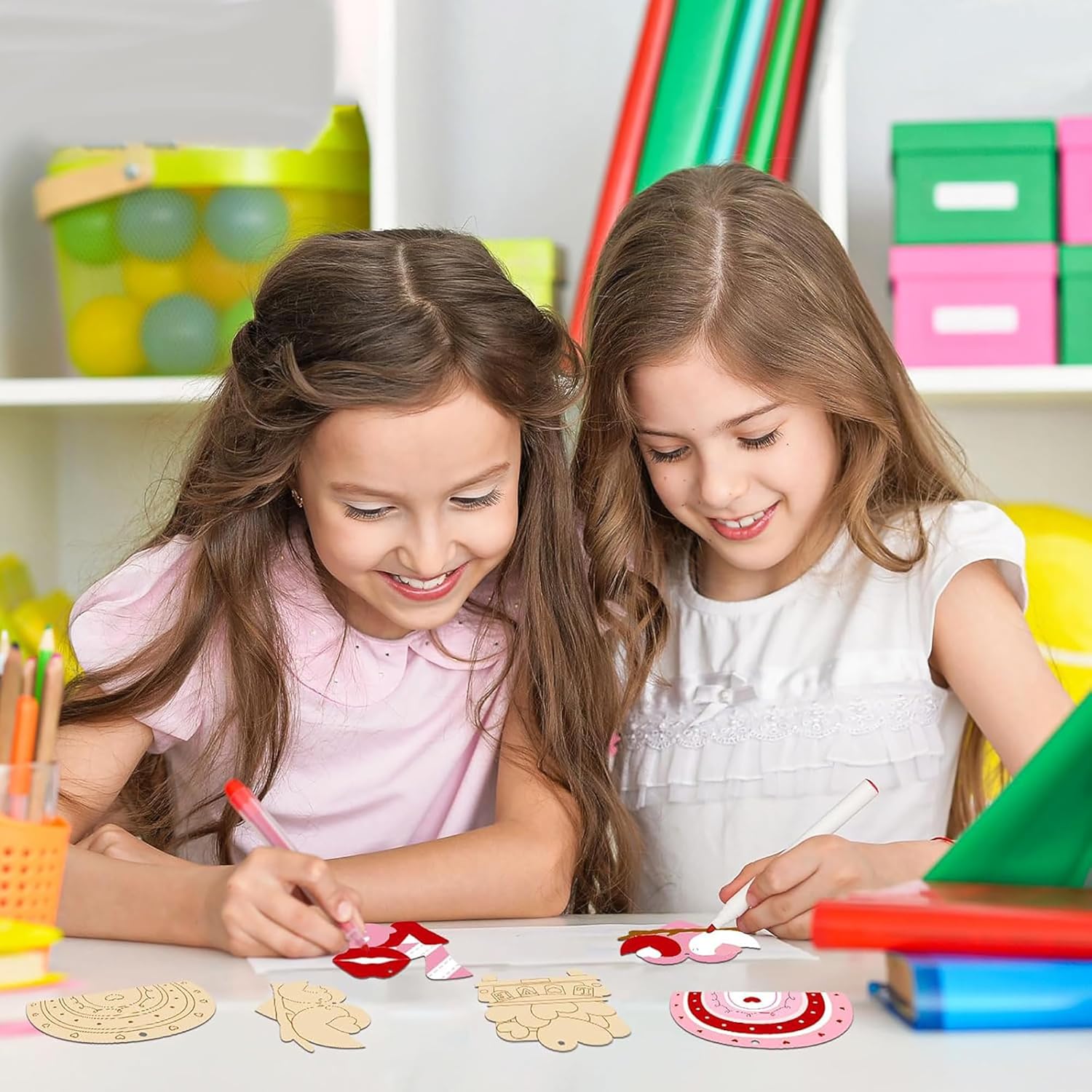 Two young girls engaged in a craft activity at a table with various materials.