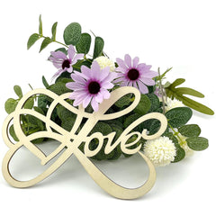 Decorative sign with 'love' and heart design on a floral background