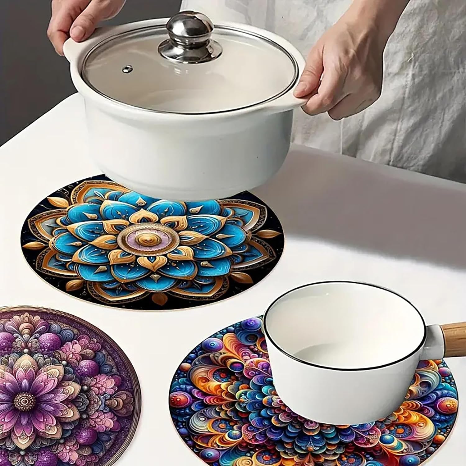 Colorful mandala coasters with a pot and mug on a table