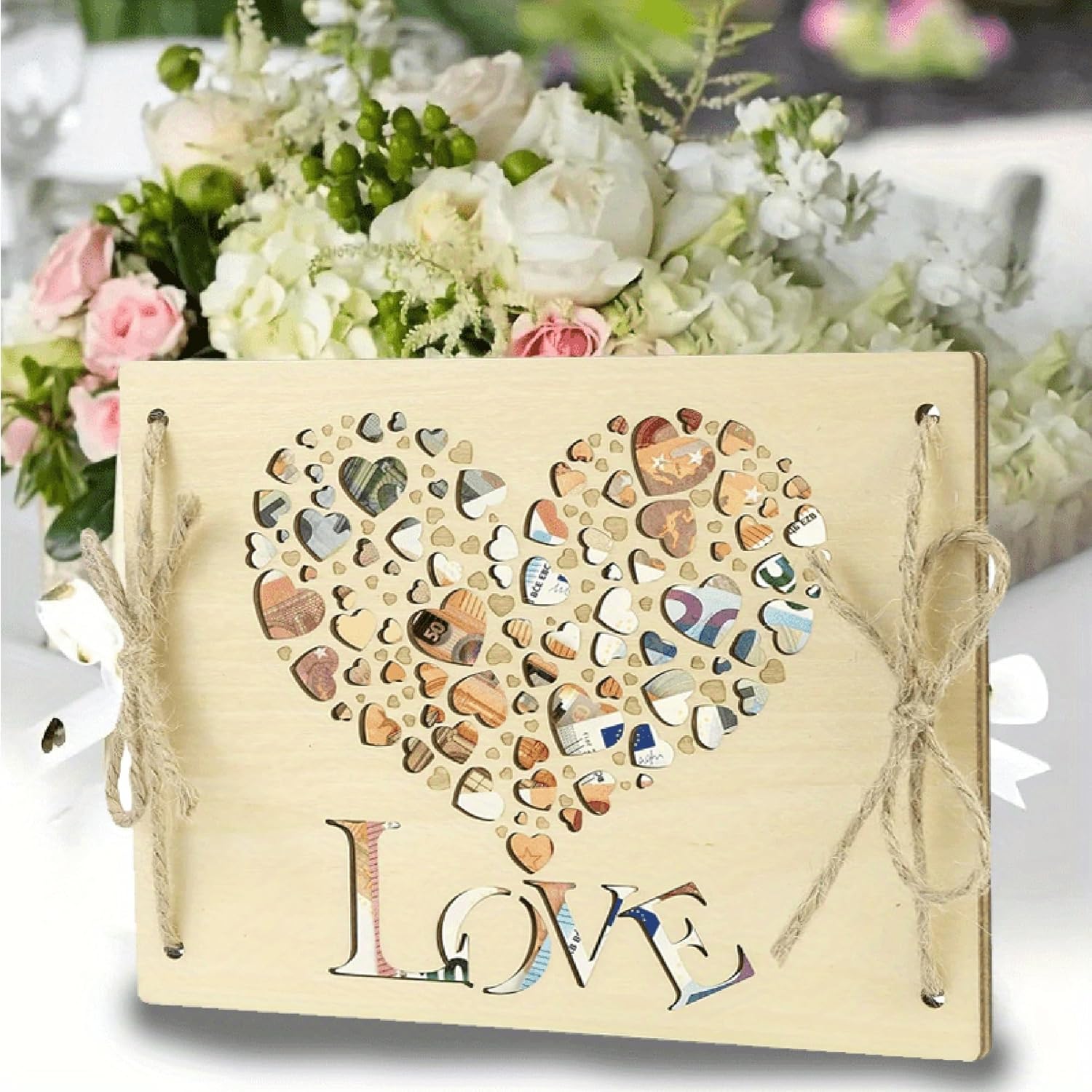 Decorative card with heart design and 'LOVE' text, tied with twine, against a floral background.