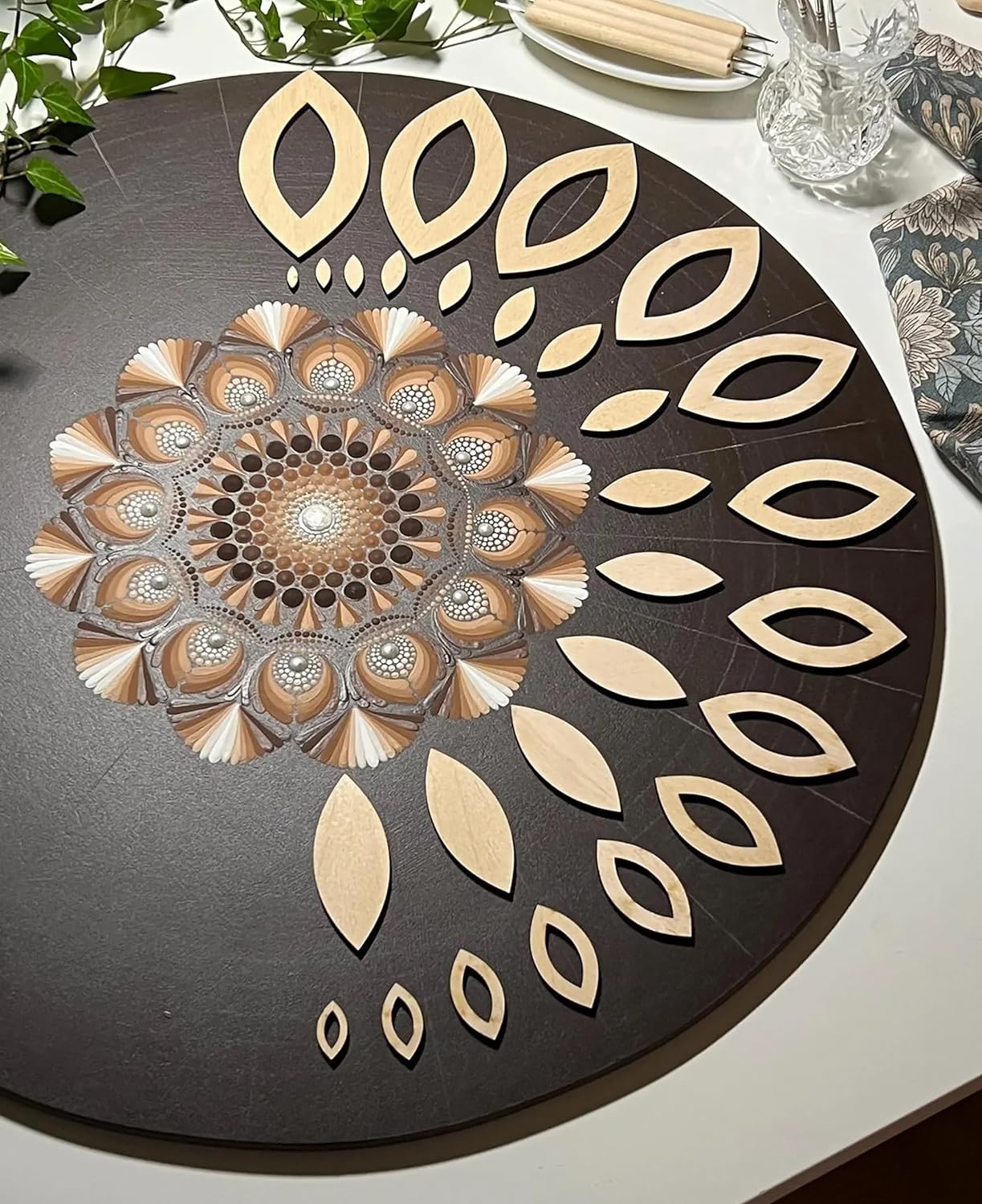 Decorative round mat with leaf pattern on a table