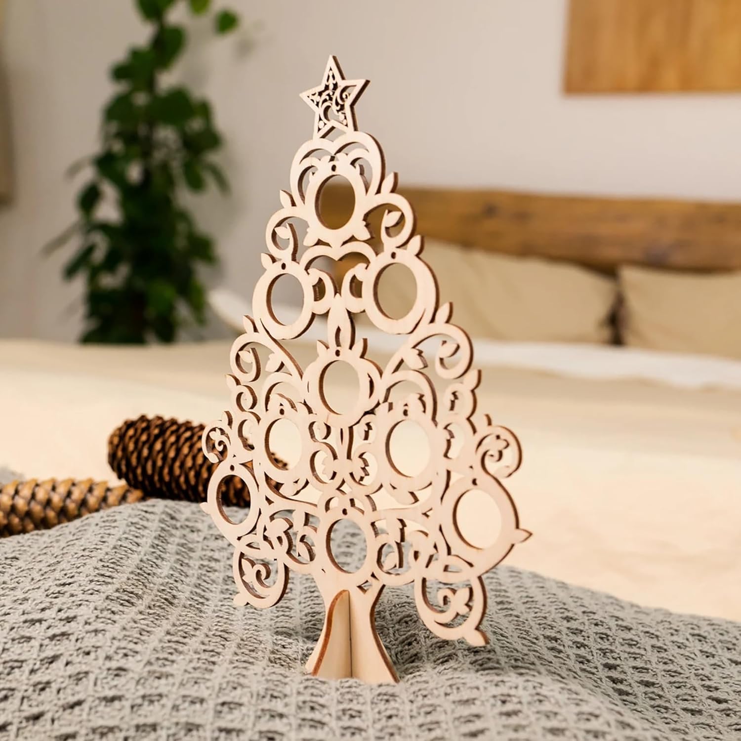 Decorative wooden Christmas tree on a bed with a blurred background