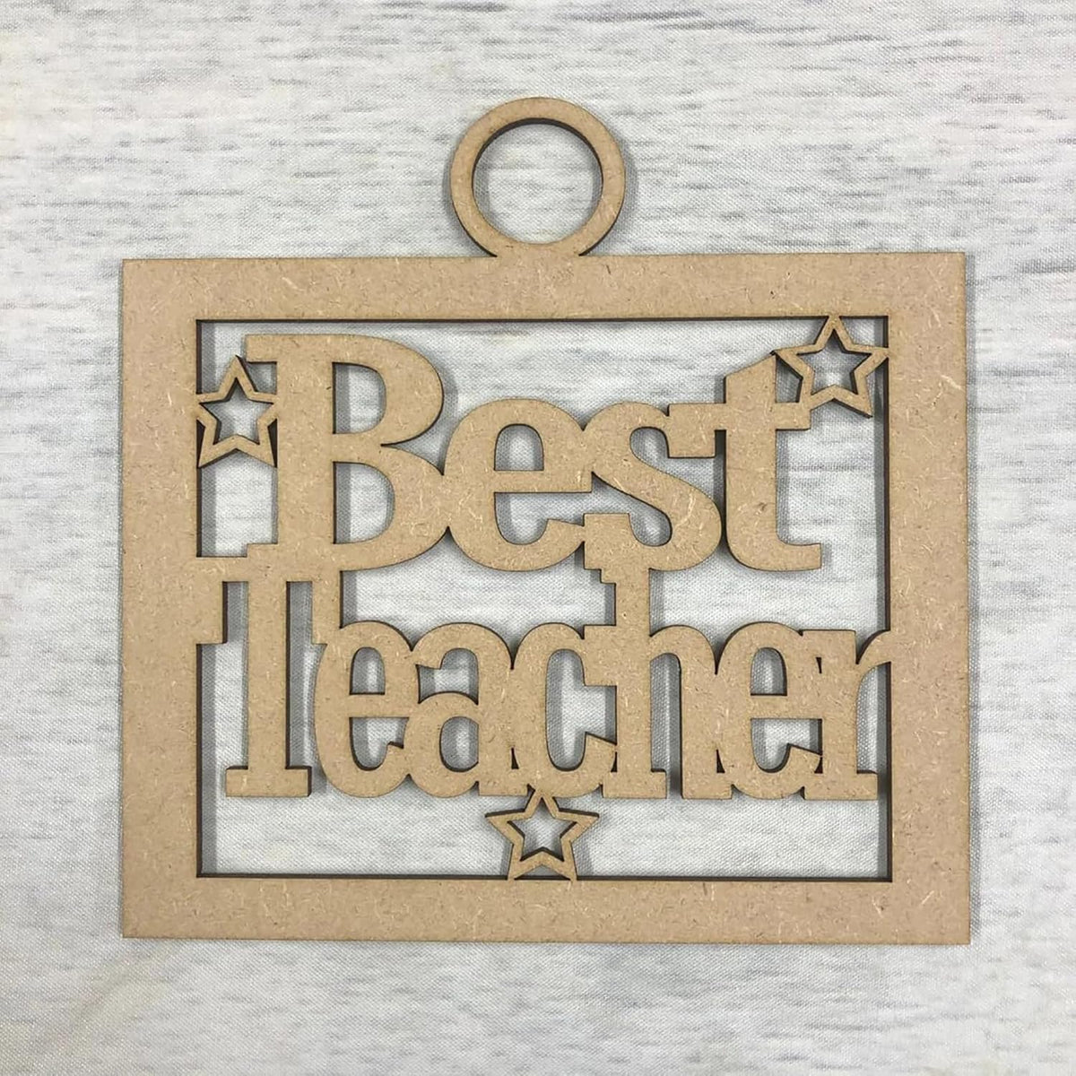 Wooden plaque with 'Best Teacher' text on a textured gray background