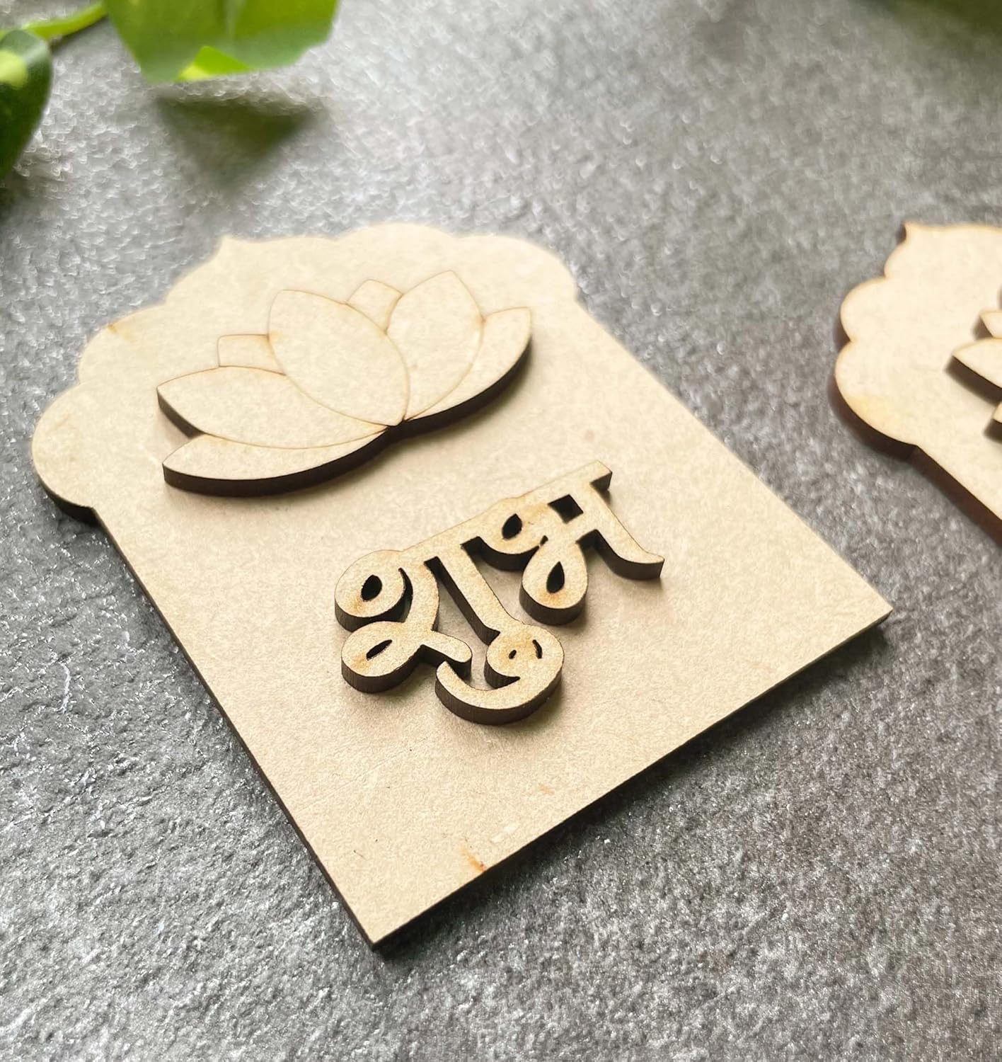 Wooden nameplate with decorative elements on a gray surface