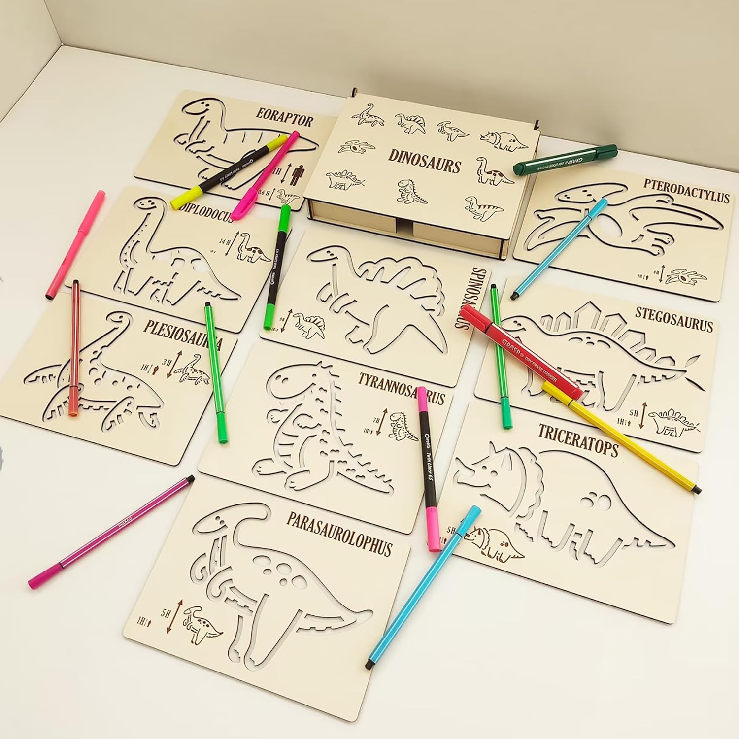 Coloring book with dinosaur illustrations and colored pencils on a white surface