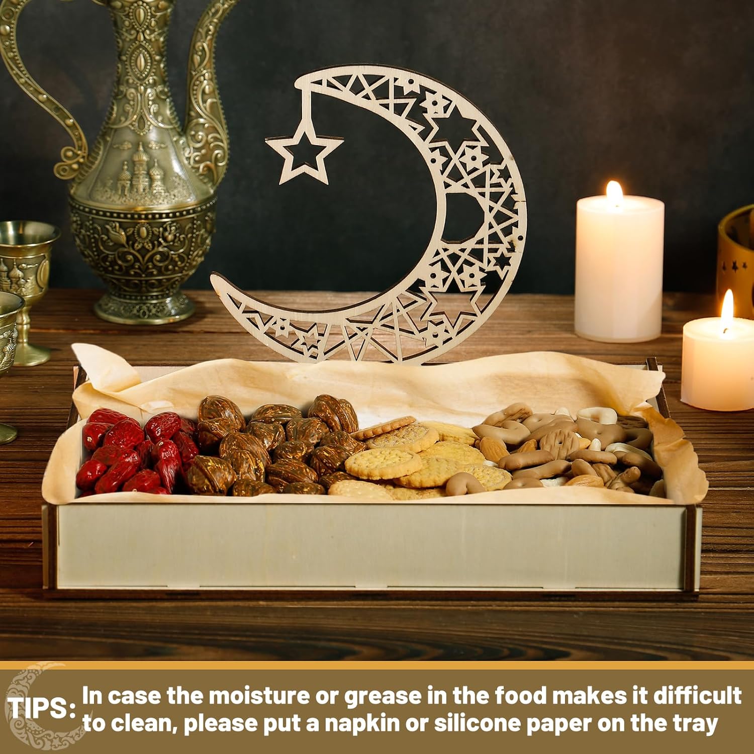 Box of assorted dried fruits and cookies with a decorative moon and star on a wooden table.