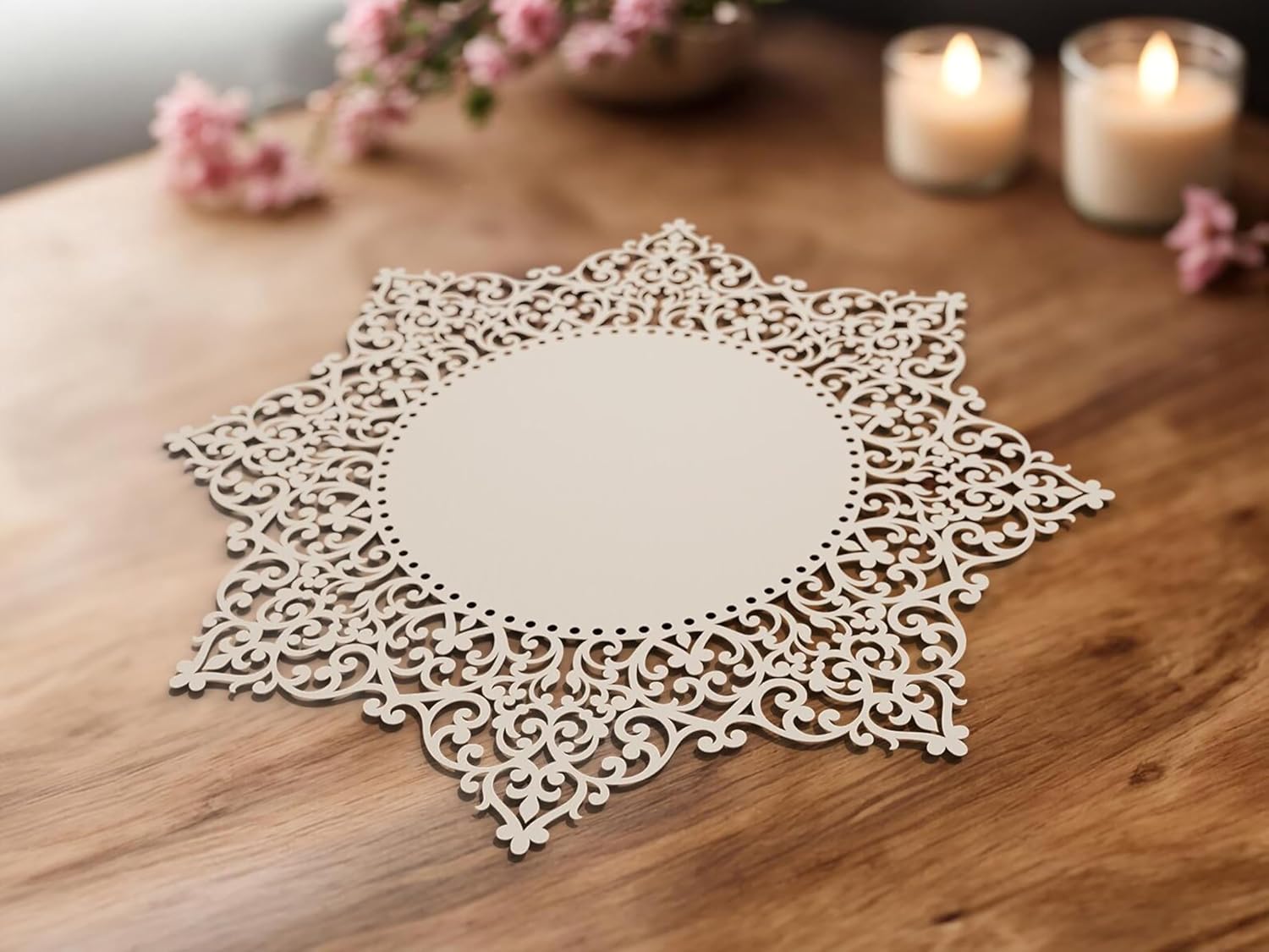 Decorative lace doily on a wooden surface with candles and flowers in the background