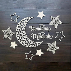 Decorative cutout of a crescent moon and stars with 'Ramadan Mubarak' text on a wooden background.