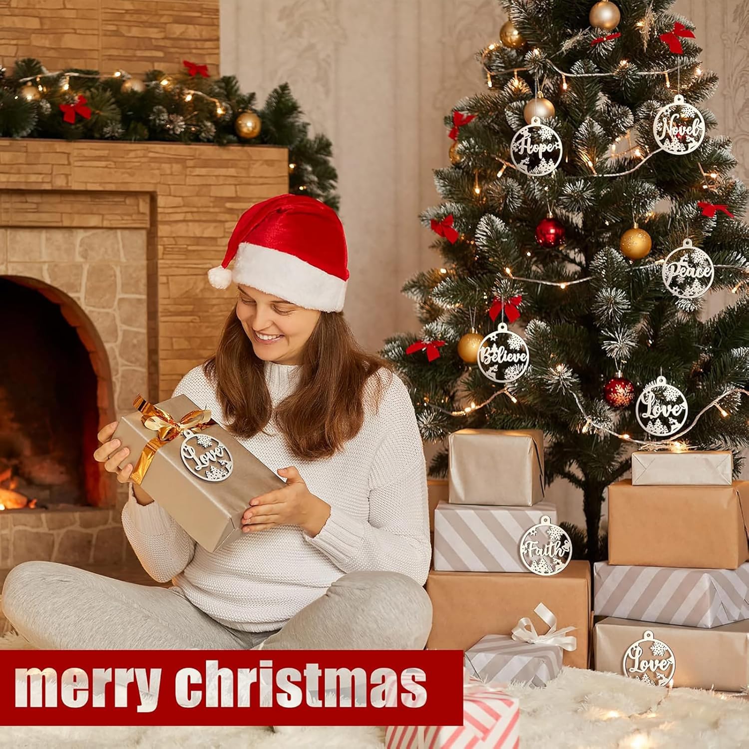 Woman in a Santa hat opening a gift in front of a decorated Christmas tree and fireplace.