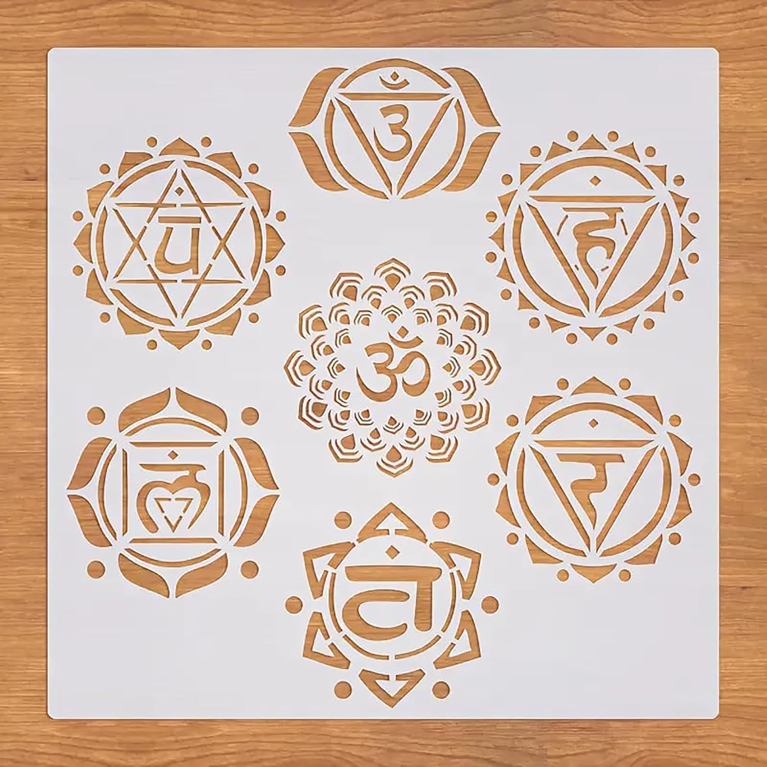 Set of gold chakra symbols on a white card with a wooden surface background