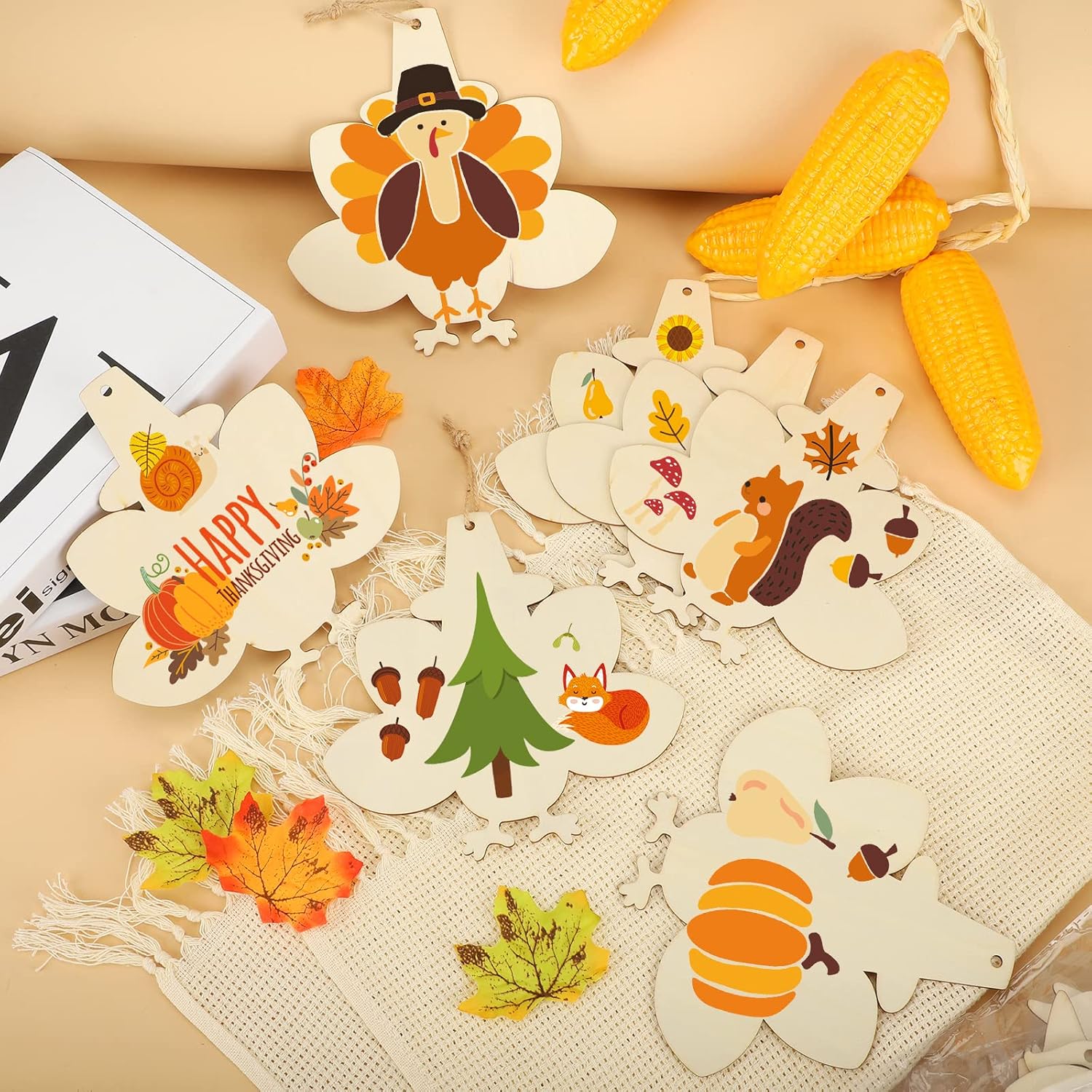 Decorative paper cutouts with autumn-themed designs on a beige surface.