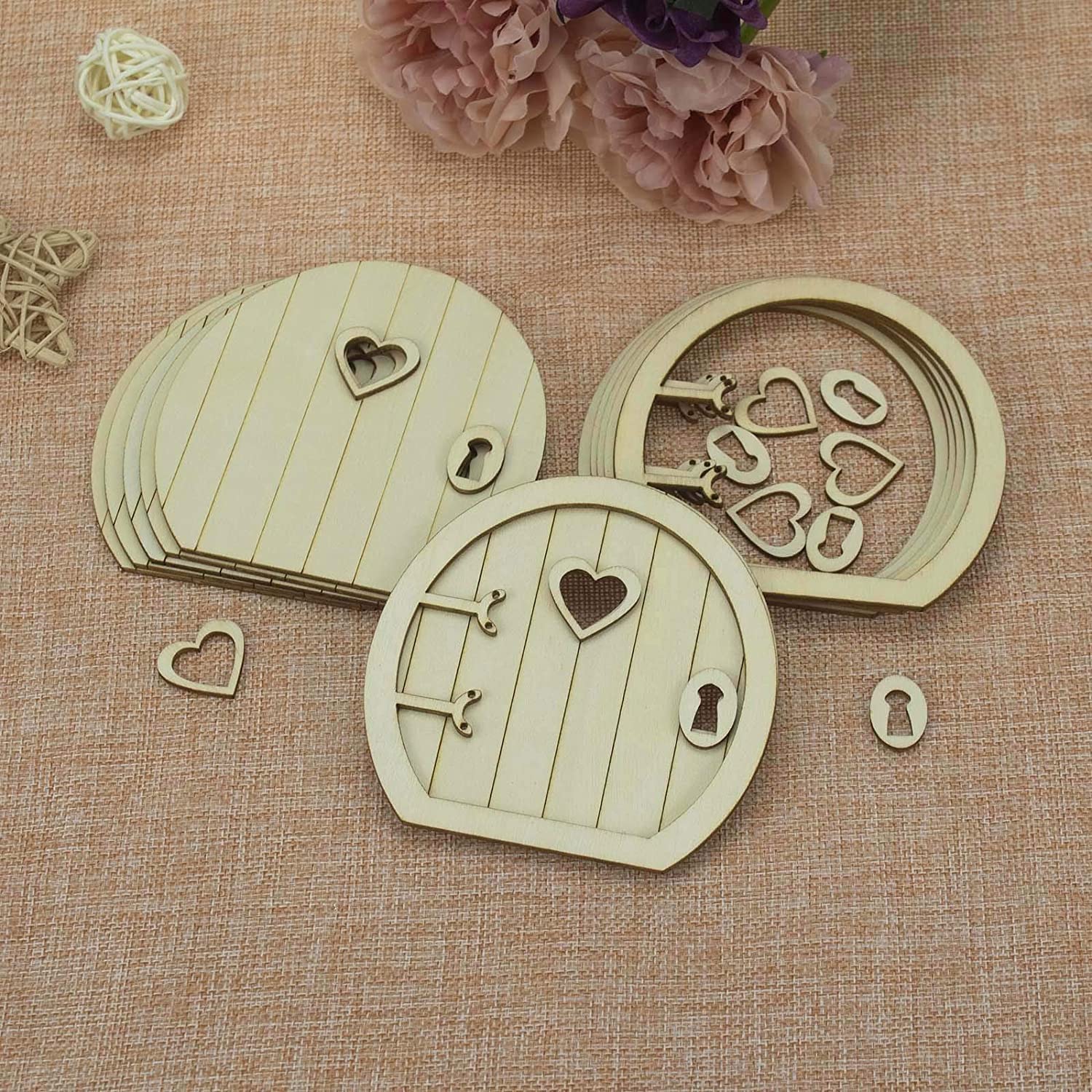 Wooden fairy doors with heart designs on a textured surface