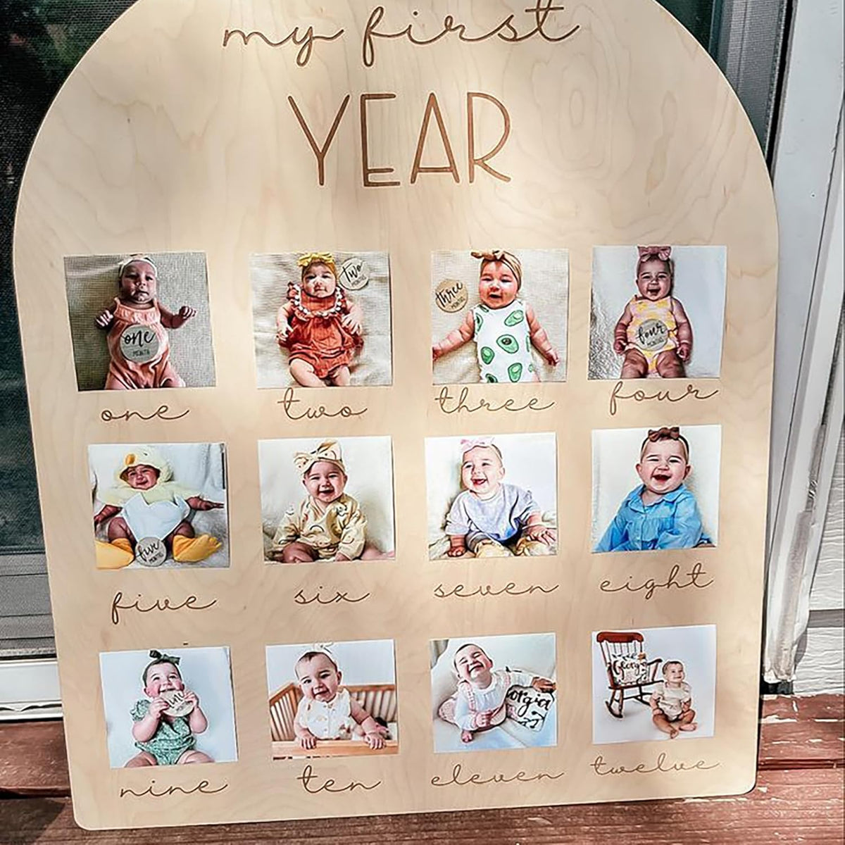 Wooden plaque with photos of a baby labeled 'my first year'