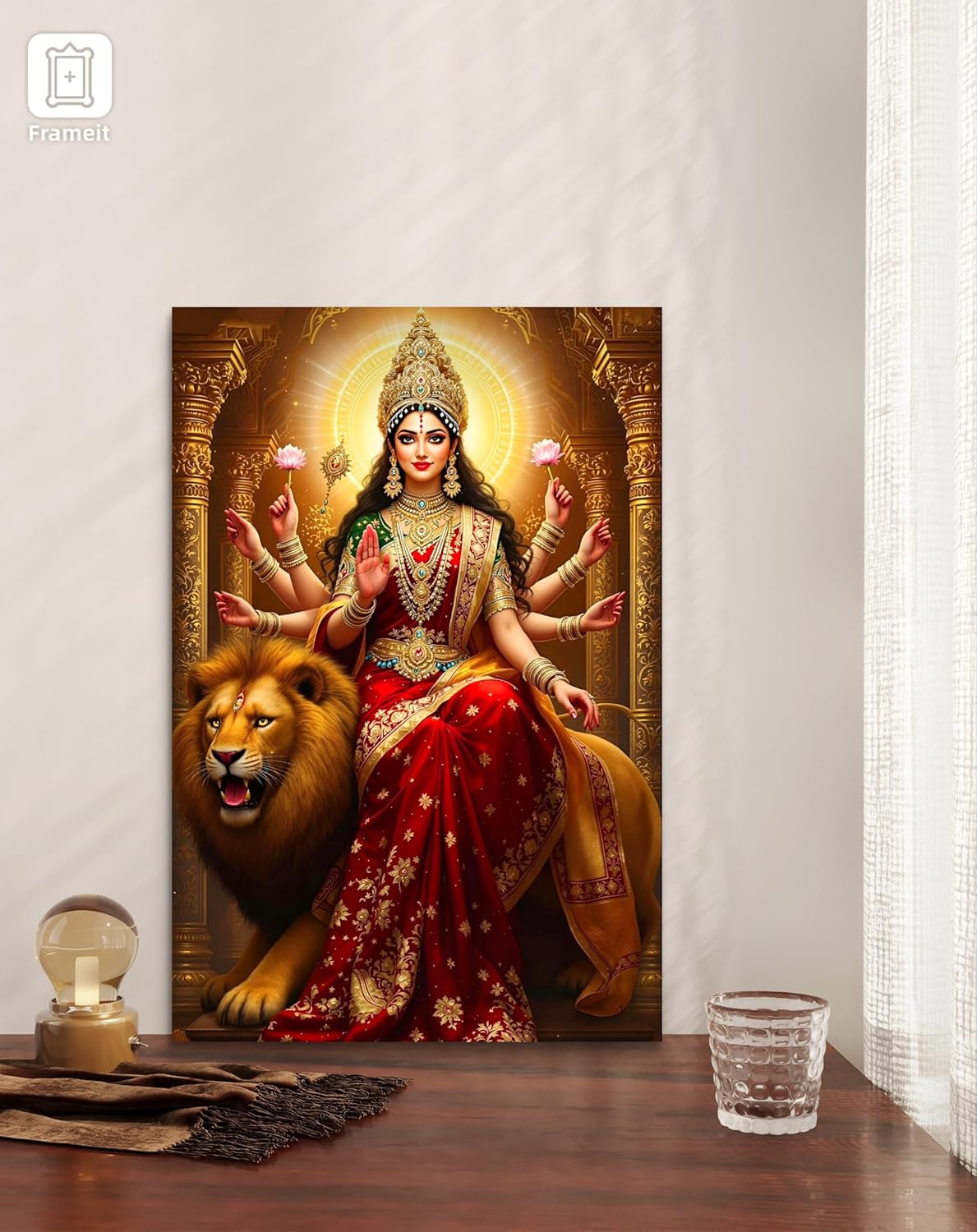 Decorative panel with a神像 of a deity sitting on a lion, framed in gold, on a wooden surface.