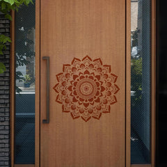 Wooden door with a decorative mandala design and metal handle.
