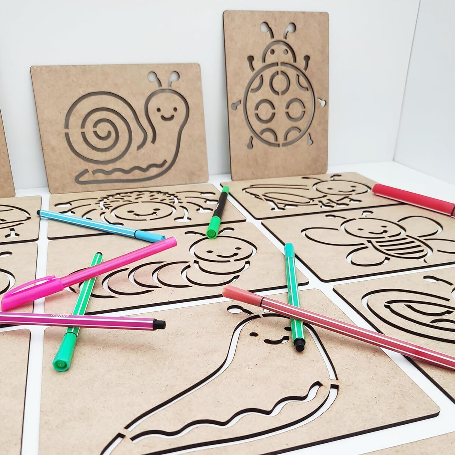 Cardboard templates with animal shapes and markers on a white background