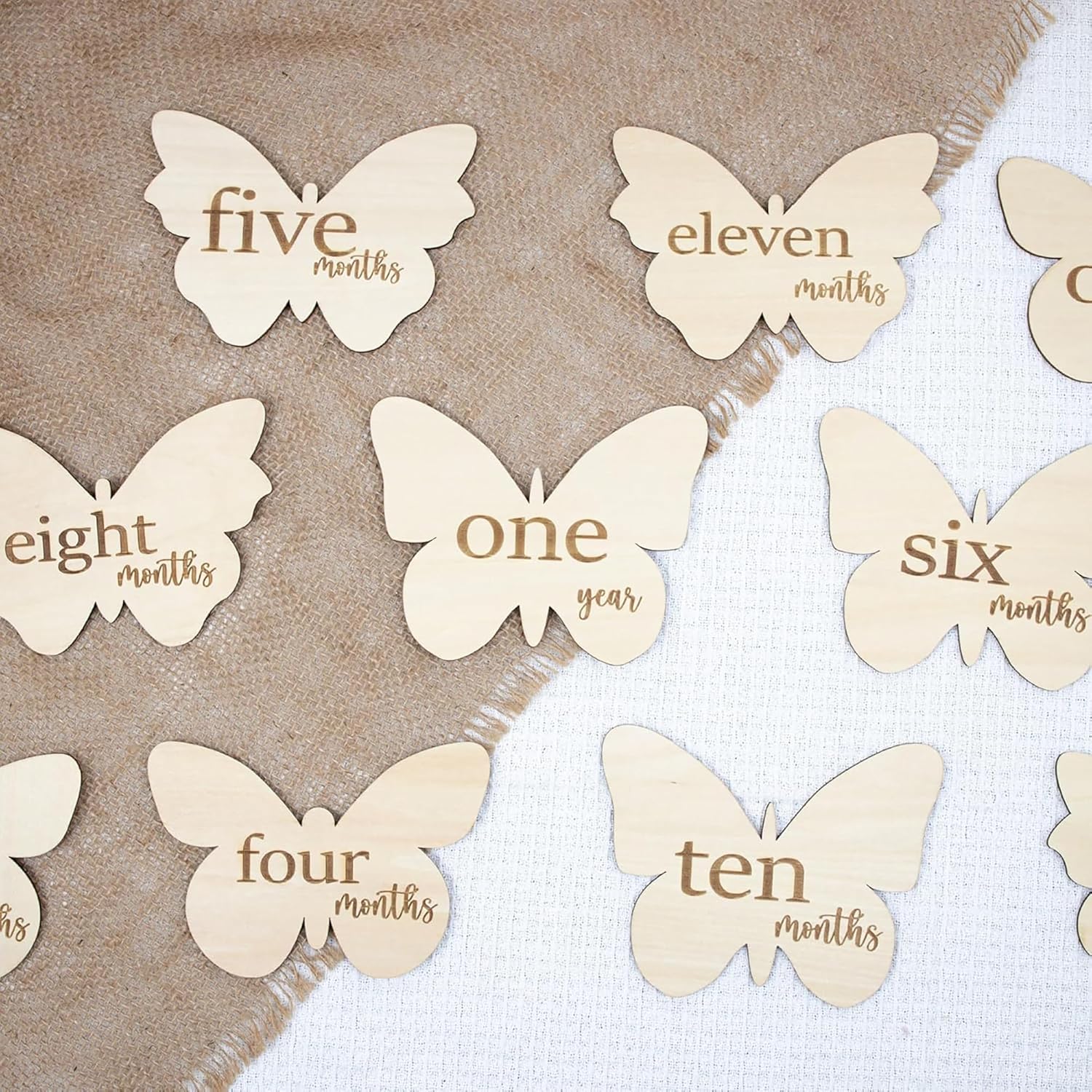 Butterfly-shaped milestone markers with text on a textured background