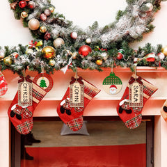 Christmas stockings with names hanging on a fireplace mantle decorated with a Christmas tree.