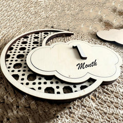 Wooden milestone with '1 Month' text on a textured surface