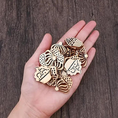 Hand holding decorative wooden pieces on a wooden surface
