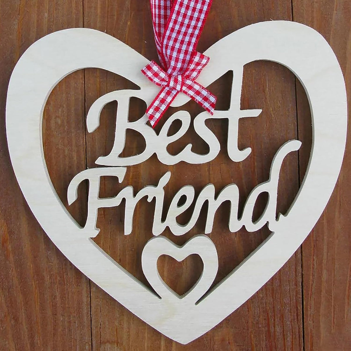 Heart-shaped wooden sign with 'Best Friend' text and a red and white checkered ribbon on a wooden background.