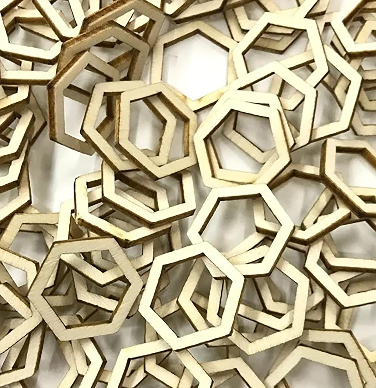 Stack of wooden hexagonal shapes on a white background