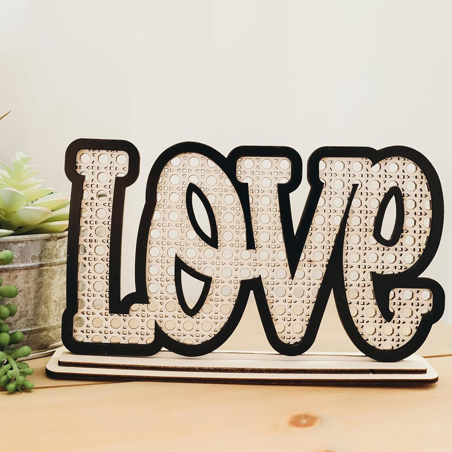 Decorative sign with 'LOVE' on a wooden surface