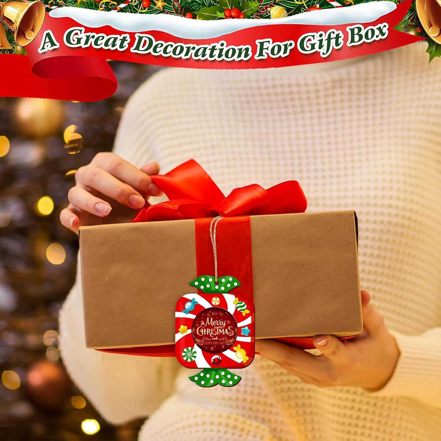 Person holding a gift box with a red ribbon and 'Merry Christmas' tag, Christmas tree in the background
