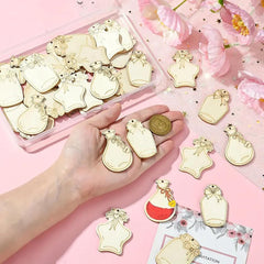 Gold bottle-shaped charms on a pink background with a hand holding two charms.