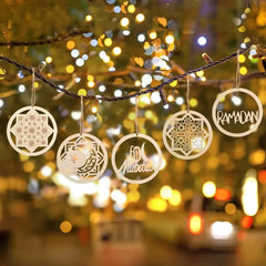 Decorative Ramadan ornaments hanging on a string with blurred lights in the background