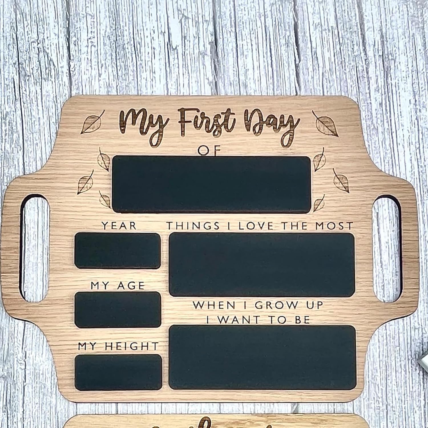 Wooden plaque with engraved text for 'My First Day' on a wooden surface