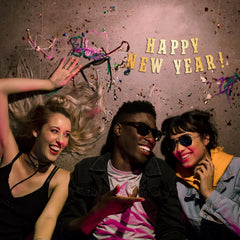 Three people celebrating with confetti and 'Happy New Year!' text on a dark background