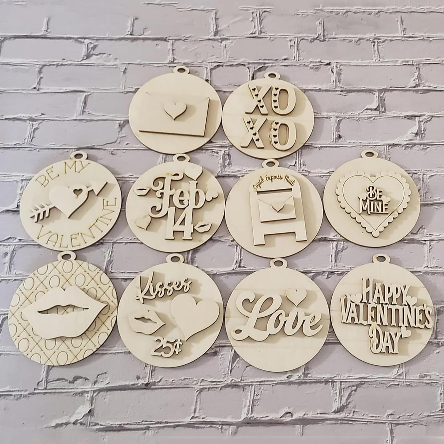 Decorative wooden tags with various inscriptions on a gray brick wall background